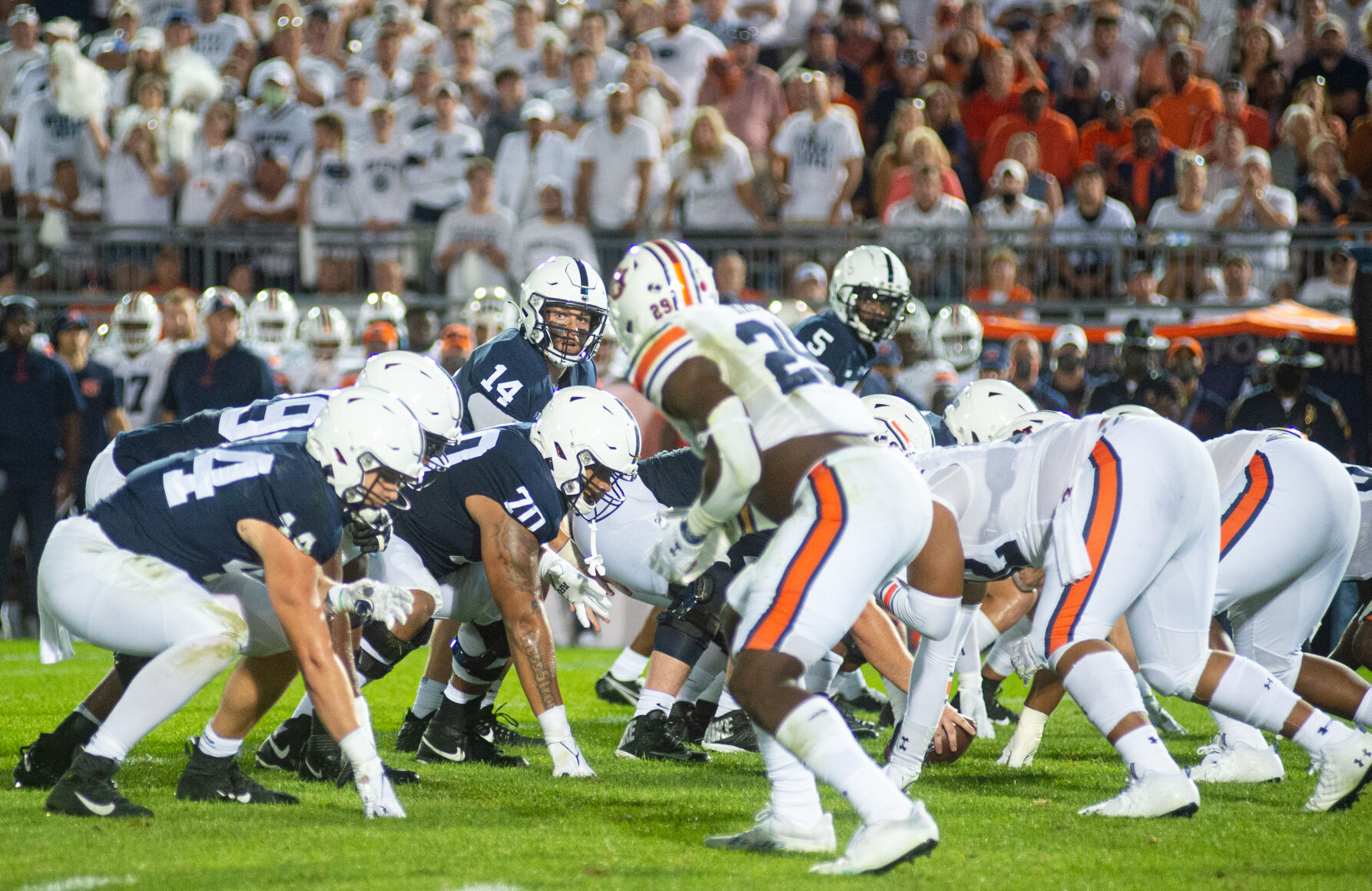 Football players get set for a play during the White Out